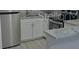 Modern kitchen with stainless steel refrigerator and range hood over white cabinets and granite counters at 5017 Steyr St, Orlando, FL 32819