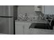 Efficient kitchen features stainless steel appliances and white cabinetry at 5017 Steyr St, Orlando, FL 32819