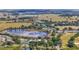 Sprawling aerial view of the community, featuring a large lake, lush landscapes, and community amenities at 5137 Links Ln, Leesburg, FL 34748
