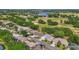 Aerial view of a neighborhood near a lush golf course and natural lake at 5137 Links Ln, Leesburg, FL 34748