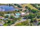 An aerial view of the community clubhouse with a pool, tennis courts, and scenic ponds at 5137 Links Ln, Leesburg, FL 34748