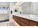 Bright bathroom featuring a double vanity with marble countertops, and a separate tub at 5137 Links Ln, Leesburg, FL 34748