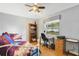 Bedroom boasting a hardwood floor, daybed and a bookshelf with a TV at 5137 Links Ln, Leesburg, FL 34748