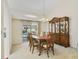 Bright dining area with elegant furniture set and a view of the pool outside at 5137 Links Ln, Leesburg, FL 34748