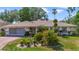Charming one-story home with well-manicured landscaping and a brick-paved driveway at 5137 Links Ln, Leesburg, FL 34748