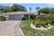 Well-maintained home featuring a two-car garage and lush front yard landscaping at 5137 Links Ln, Leesburg, FL 34748