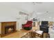 Comfortable living room with a wood-burning fireplace and views into the kitchen at 5137 Links Ln, Leesburg, FL 34748