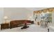 Bright living room with classic decor, carpet flooring, and large windows at 5137 Links Ln, Leesburg, FL 34748