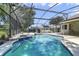 Screened-in pool area with an attached hot tub and sunny skies overhead at 5137 Links Ln, Leesburg, FL 34748