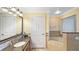 Bathroom features a large mirror, granite countertops, double sink, a bathtub and a toilet at 7683 Heritage Crossing Way # 202, Reunion, FL 34747
