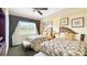 Inviting guest bedroom with two beds, neutral decor, and a large window at 7683 Heritage Crossing Way # 202, Reunion, FL 34747