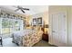 Cozy bedroom featuring a ceiling fan, a sliding door to the balcony and tropical style artwork at 7683 Heritage Crossing Way # 202, Reunion, FL 34747