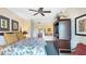 Well-lit bedroom includes TV, ceiling fan, decorative pillows and artwork on the walls at 7683 Heritage Crossing Way # 202, Reunion, FL 34747