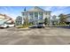 Well-maintained building featuring classic architectural details, ample parking, and a professionally landscaped exterior at 7683 Heritage Crossing Way # 202, Reunion, FL 34747