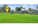 Well-manicured golf course near white buildings and blue skies at 7683 Heritage Crossing Way # 202, Reunion, FL 34747