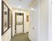 Laundry room with stacked washer and dryer unit in a closet with bi-fold doors at 7683 Heritage Crossing Way # 202, Reunion, FL 34747