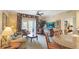 Comfortable living room with elegant decor and a view to the outside balcony at 7683 Heritage Crossing Way # 202, Reunion, FL 34747