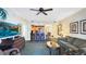 Open-concept living room with an island to the kitchen, ceiling fan and decorative wall art at 7683 Heritage Crossing Way # 202, Reunion, FL 34747