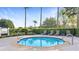 Relaxing community hot tub surrounded by lush landscaping and seating at 7683 Heritage Crossing Way # 202, Reunion, FL 34747