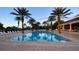 Relaxing pool area with lounge chairs and palm trees at 7683 Heritage Crossing Way # 202, Reunion, FL 34747