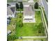 Aerial view of a fenced backyard with a large lawn and patio with screened in porch at 7716 Park Hill Ave, Leesburg, FL 34748