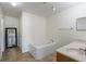 Bathroom featuring a soaking tub, and a vanity with stone countertop at 7716 Park Hill Ave, Leesburg, FL 34748