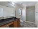 Well-lit bathroom featuring a glass-enclosed shower and vanity at 7716 Park Hill Ave, Leesburg, FL 34748