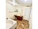 Bright bathroom featuring a soaking tub and granite countertop vanity at 7716 Park Hill Ave, Leesburg, FL 34748