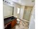 Standard bathroom featuring a shower stall, single sink, and tile floors at 7716 Park Hill Ave, Leesburg, FL 34748