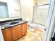 Standard bathroom with single granite countertop sink and shower stall at 7716 Park Hill Ave, Leesburg, FL 34748