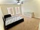 Bedroom with beige carpet, a fan and natural light from two windows at 7716 Park Hill Ave, Leesburg, FL 34748