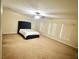 Spacious bedroom with carpeted floor and lots of light from three windows at 7716 Park Hill Ave, Leesburg, FL 34748