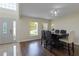 Bright dining room featuring hardwood floors, a modern light fixture, and an inviting atmosphere at 7716 Park Hill Ave, Leesburg, FL 34748