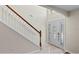 Bright entryway with tiled floors, a staircase with wood accents, and a decorative front door with sidelights at 7716 Park Hill Ave, Leesburg, FL 34748