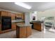 Open eat-in kitchen with stainless steel appliances, central island, and plenty of cabinet space for storage at 7716 Park Hill Ave, Leesburg, FL 34748