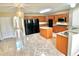 Spacious eat-in kitchen with wood cabinetry, black appliances, and center island at 7716 Park Hill Ave, Leesburg, FL 34748
