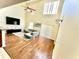 Vaulted living room featuring hardwood floors and ample natural light at 7716 Park Hill Ave, Leesburg, FL 34748