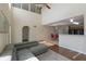 Open living space featuring a vaulted ceiling, hardwood floors, and an adjacent tiled eat-in kitchen at 7716 Park Hill Ave, Leesburg, FL 34748