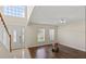 Welcoming living room with hardwood floors, a bright window display, and an elegant front door at 7716 Park Hill Ave, Leesburg, FL 34748