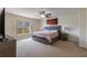 Modern main bedroom boasts a large window, grey decor, and accent art at 7716 Park Hill Ave, Leesburg, FL 34748