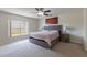Modern main bedroom boasts a large window, grey decor, and accent art at 7716 Park Hill Ave, Leesburg, FL 34748