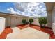 Backyard featuring a cozy patio space surrounded by red mulch and a white privacy fence at 8612 Brookvale Dr, Windermere, FL 34786