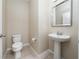 Well-lit half bathroom featuring a pedestal sink and a neutral color scheme at 8612 Brookvale Dr, Windermere, FL 34786