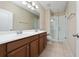 Spacious bathroom featuring a double vanity, mirror, and a glass-enclosed shower at 8612 Brookvale Dr, Windermere, FL 34786