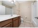 Bright bathroom featuring a large mirror, wood-stained cabinets and a shower and tub combo at 8612 Brookvale Dr, Windermere, FL 34786