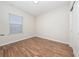 Bright bedroom features wood-look floors, a window with blinds, and a closet for ample storage at 8612 Brookvale Dr, Windermere, FL 34786