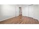 Bedroom featuring wood floors, neutral paint, and closet space at 8612 Brookvale Dr, Windermere, FL 34786