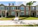 Charming townhome with manicured landscaping and a neutral color palette, complemented by a mature palm tree at 8612 Brookvale Dr, Windermere, FL 34786