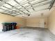 Spacious garage with ample storage space and a secure door, perfect for parking and hobbies at 8612 Brookvale Dr, Windermere, FL 34786