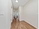 Bright hallway with wood floors connecting multiple rooms and featuring neutral walls at 8612 Brookvale Dr, Windermere, FL 34786